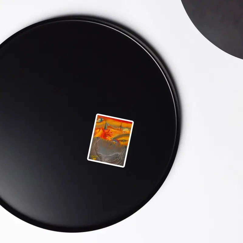 Black circular plate with an orange card, featured in Above the Shadows Surrealist Magnet