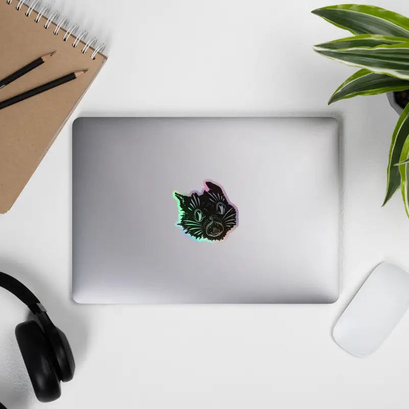 Laptop adorned with an enchanted kitty head holographic sticker for mesmerizing decor
