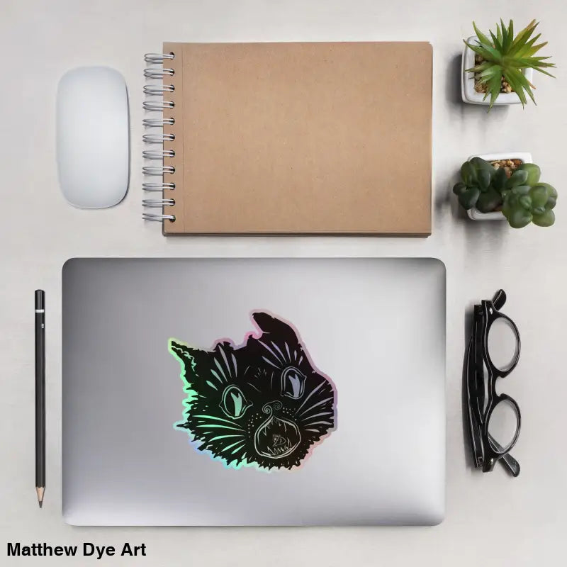 Laptop adorned with an enchanted kitty head holographic sticker for spooky decor