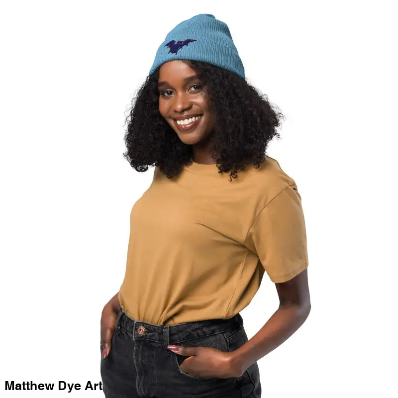 Light blue knit beanie with dark blue bat, perfect for a cozy, spooky autumn