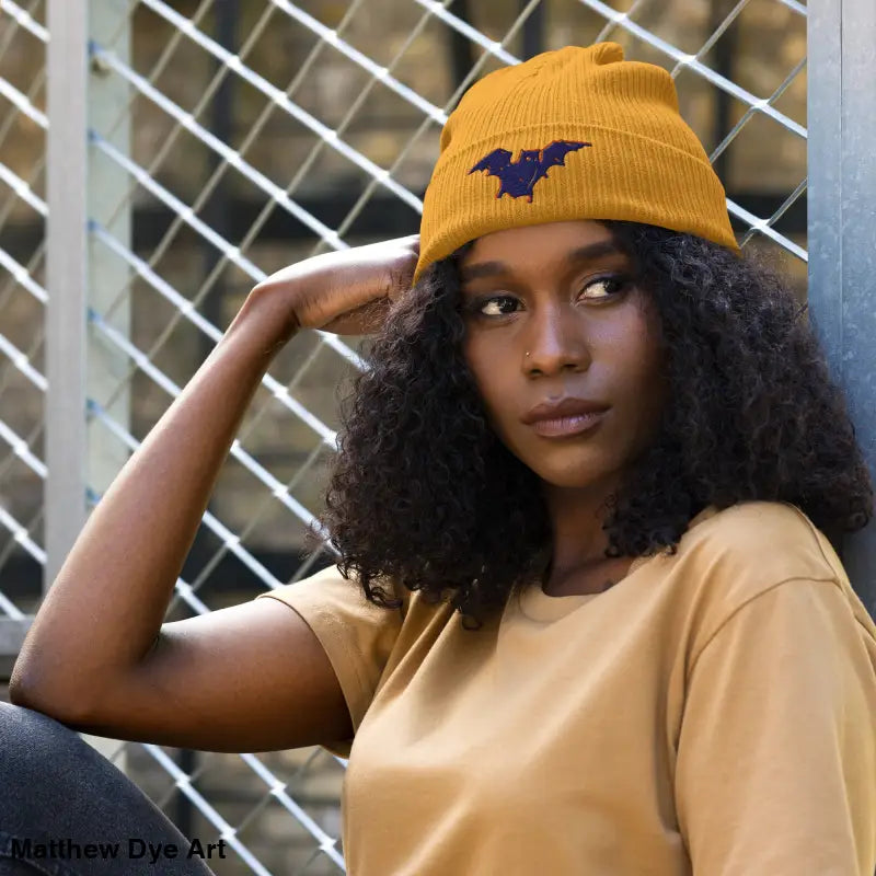 Mustard-colored beanie with bat emblem, perfect for autumn and Halloween adventures