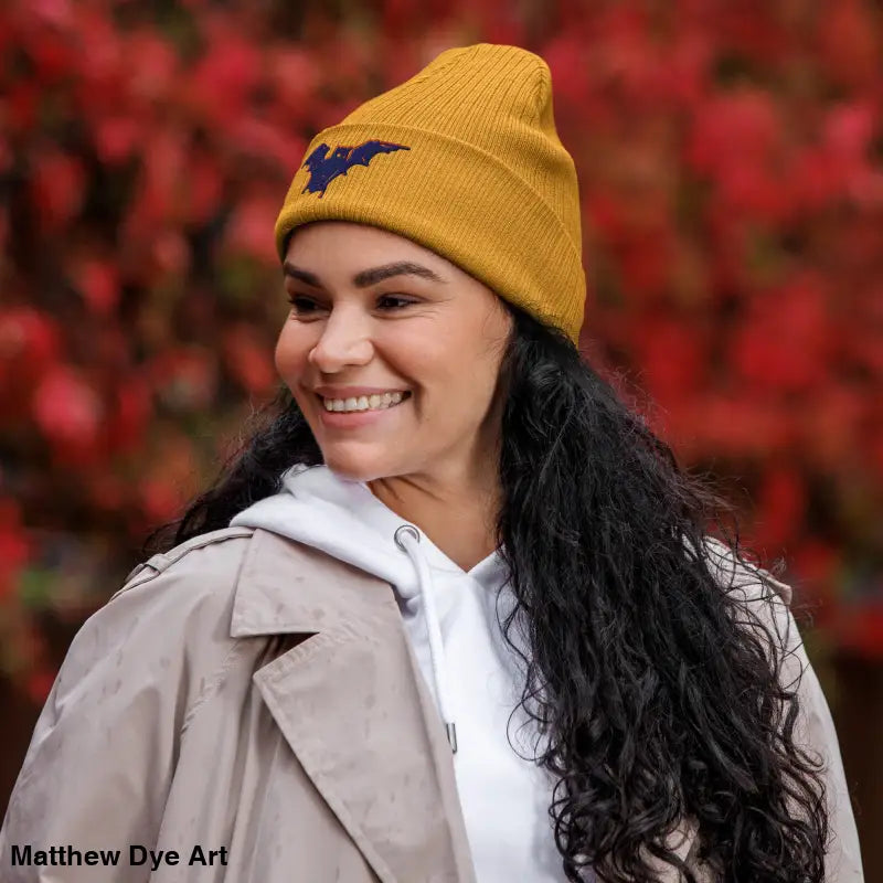 Mustard-yellow knit beanie with bat emblem, perfect for autumn and Halloween wear