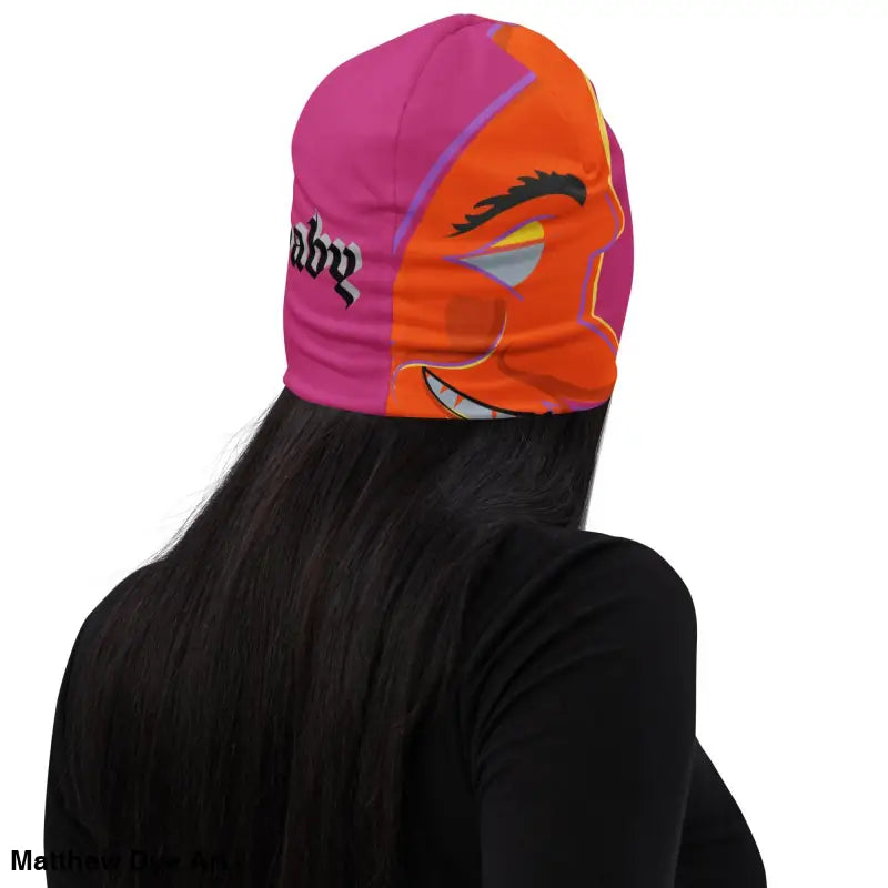 Pink and orange beanie featuring a whimsical cartoon face for the Bat Baby collection