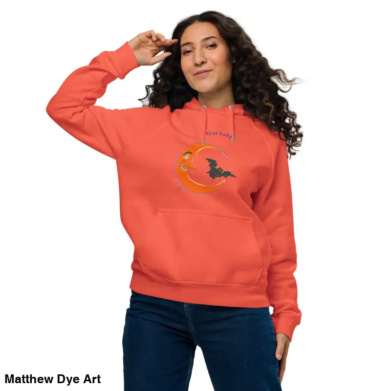 Woman in orange hoodie showcasing the Bat Baby Unisex Art Hoodie for playful retro Halloween