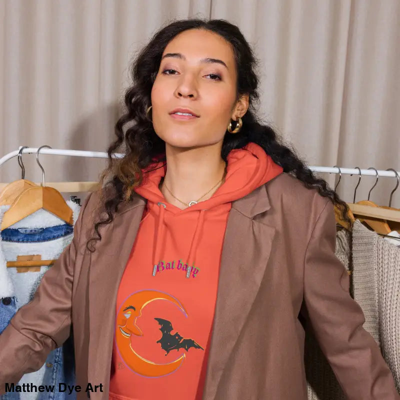 Woman in a brown blazer over an orange hoodie showcasing the Bat Baby Unisex Art Hoodie