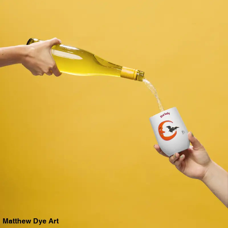 Wine being poured into a Bat Baby stainless steel tumbler for a retro Halloween experience
