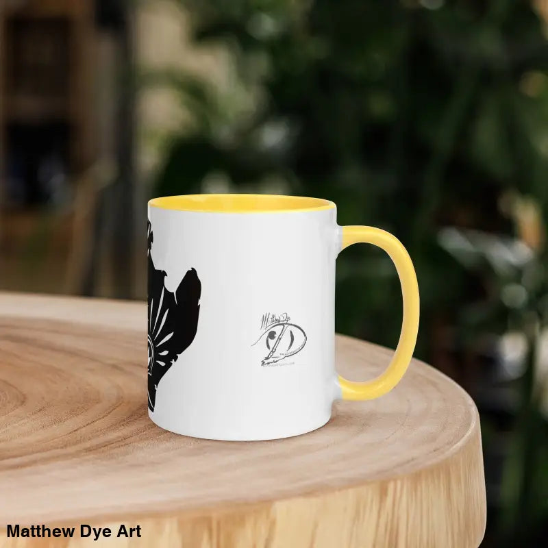 White ceramic mug with yellow handle featuring black butterfly design for whimsical kitty head