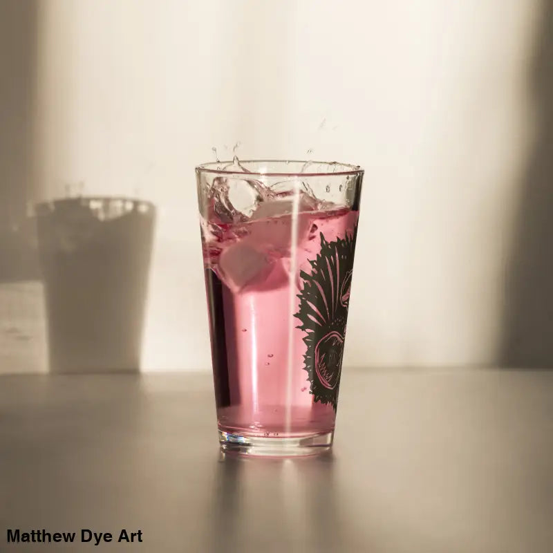 Pink liquid in patterned glass of Ah Kitty Head Halloween Pint Glass