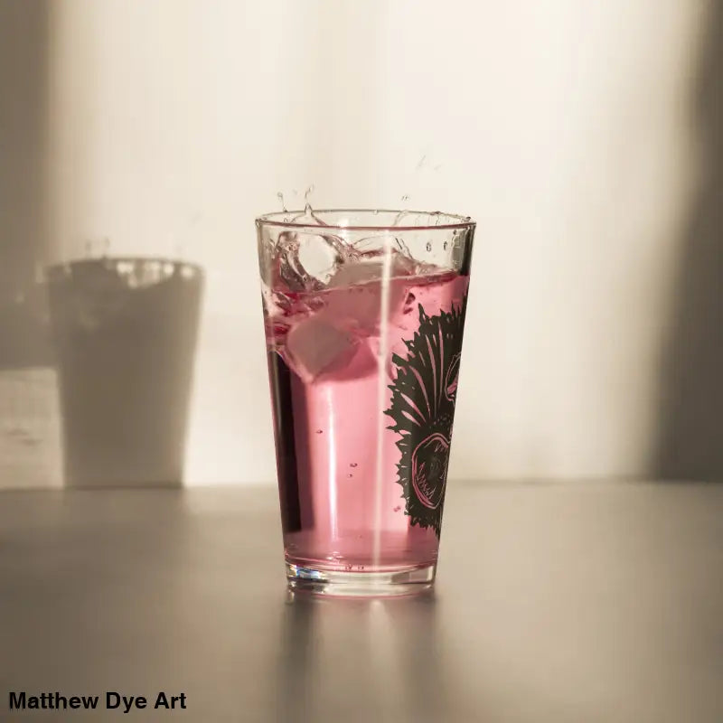 Pink liquid in patterned glass of Ah Kitty Head Halloween Pint Glass