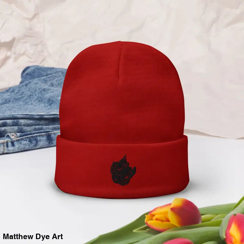 Red knit beanie featuring spooky cat embroidered design from Hexed & Headstrong