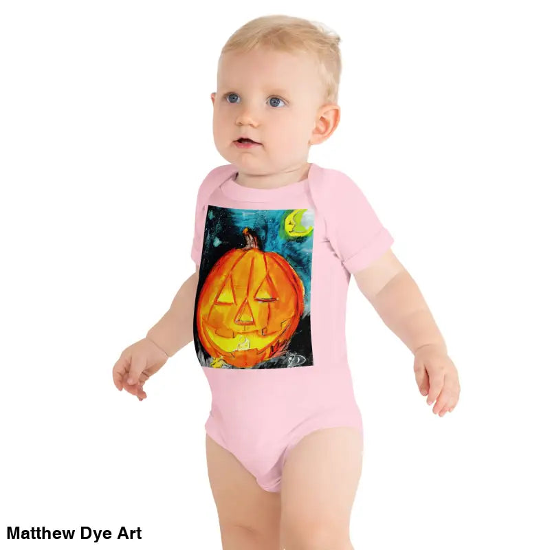 Baby in a pink Halloween-themed onesie made of combed ring-spun cotton and an adorable jack-o’-lantern