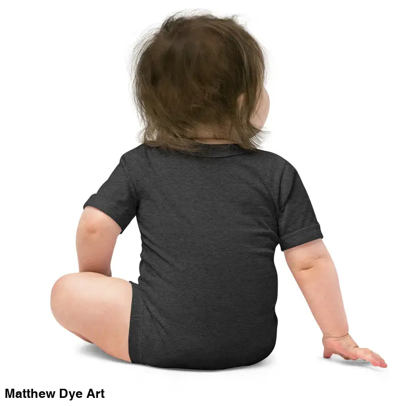 Baby in a black onesie featuring an adorable jack-o’-lantern design for Halloween