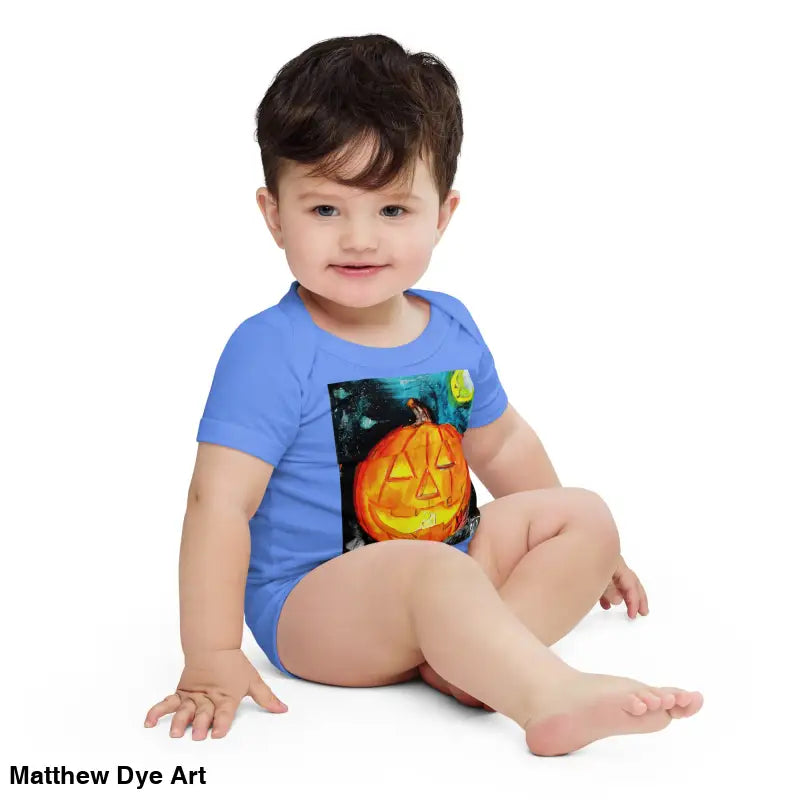 Baby in blue pumpkin onesie made of combed ring-spun cotton for an adorable jack-o’-lantern look