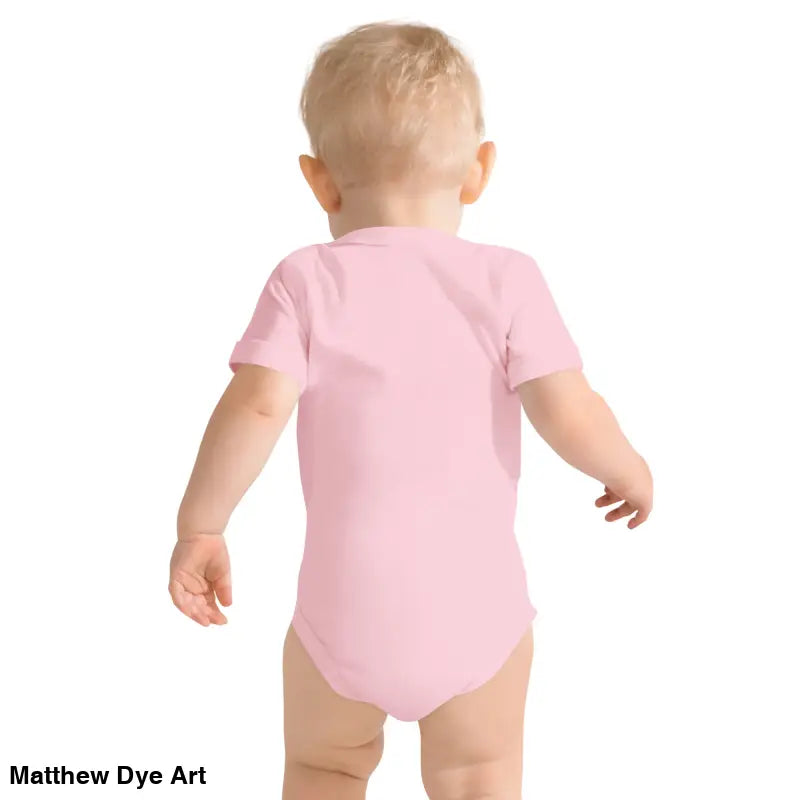 Baby in pink onesie featuring adorable jack-o’-lantern for Halloween fun