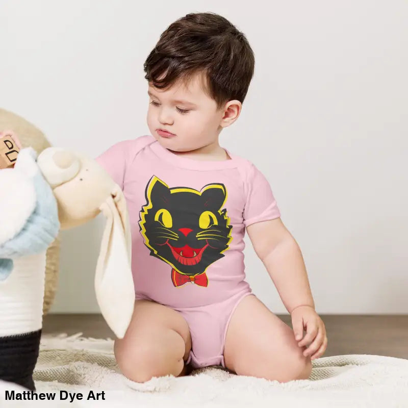 Baby in pink cat bodysuit from Little Pumpkin featuring a vintage black cat design