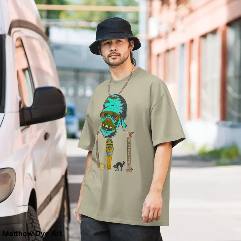 Man showcasing a mummy unisex oversized faded t-shirt with a nostalgic Halloween design