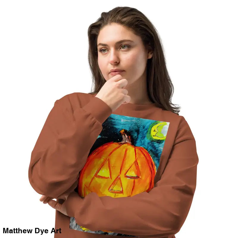 Brown sweatshirt featuring Matthew Dye Art’s whimsical jack-o’-lantern design