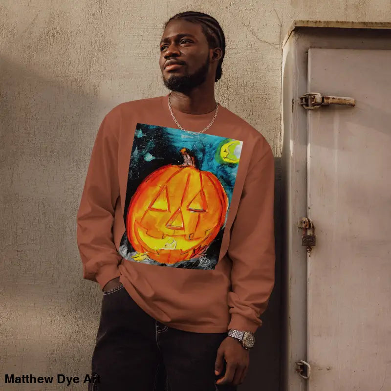 Man in pumpkin-themed long sleeve featuring Matthew Dye Art’s whimsical jack-o’-lantern design