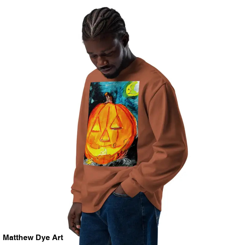 Man wearing Pumpkin Mischief sweatshirt featuring Matthew Dye Art’s whimsical Jack-o’-Lantern