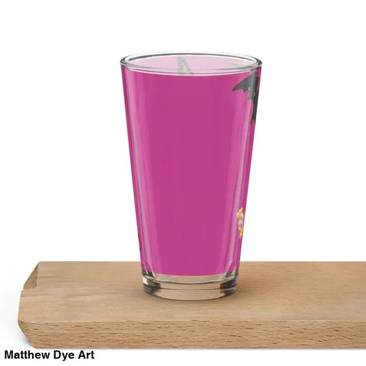Clear drinking glass filled with bright pink liquid for enchanting Pumpkin Witch party
