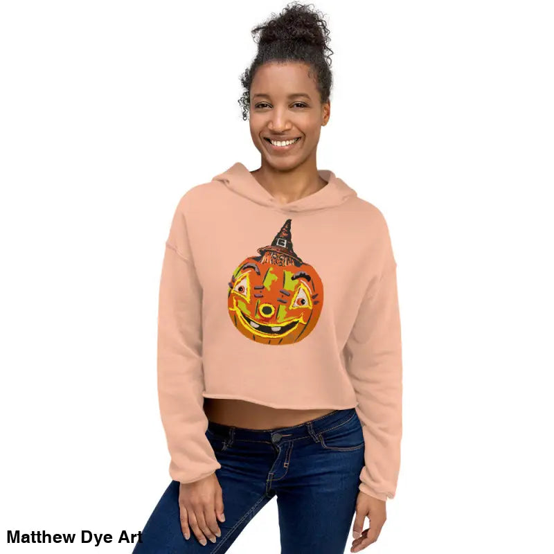 Woman in a cropped Halloween hoodie featuring an enchanted pumpkin witch design