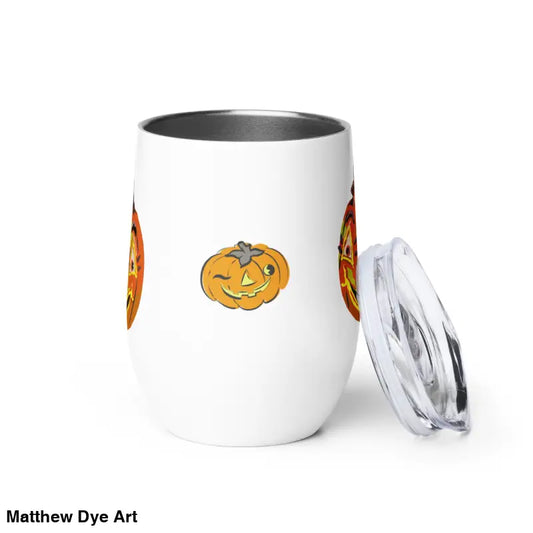 White tumbler featuring whimsical pumpkin witch designs from Matthew Dye Art