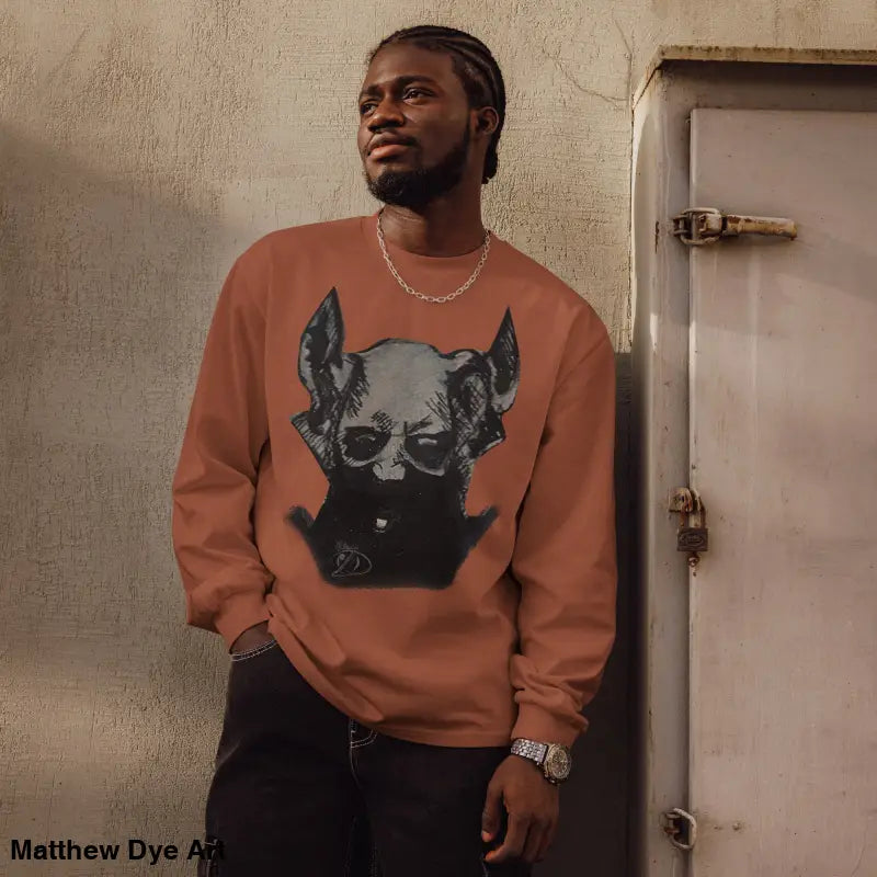 Man in premium long sleeve Sinister Embrace shirt featuring a skull graphic