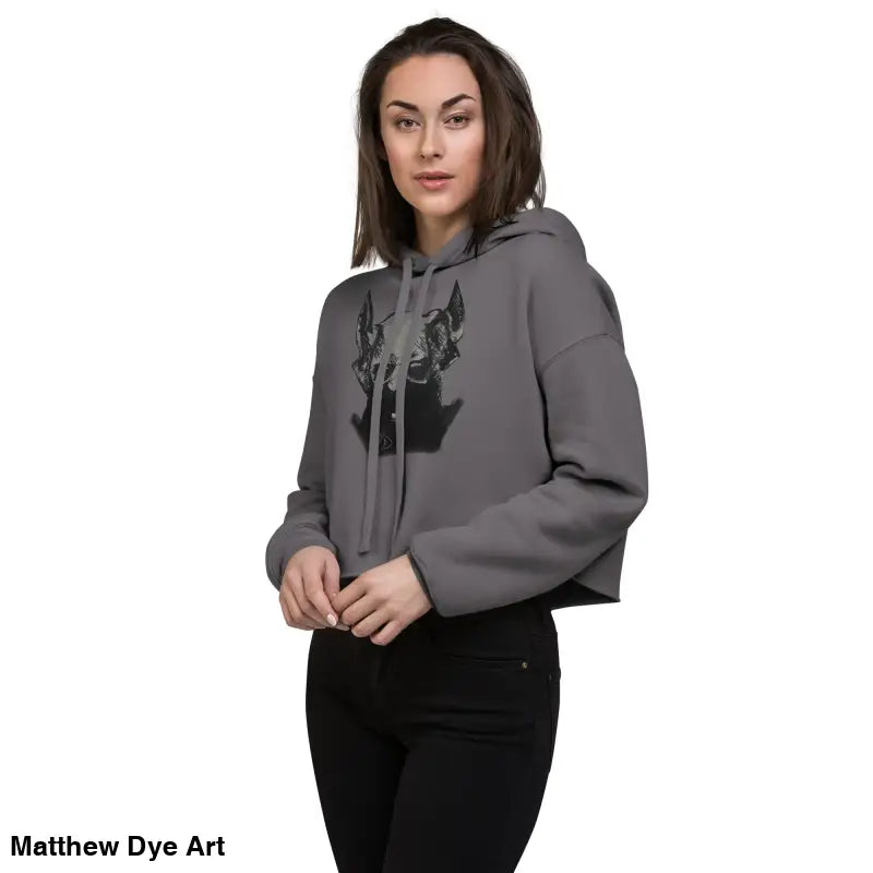 Woman in gray cropped hoodie featuring sinister figure design and dropped shoulder cut