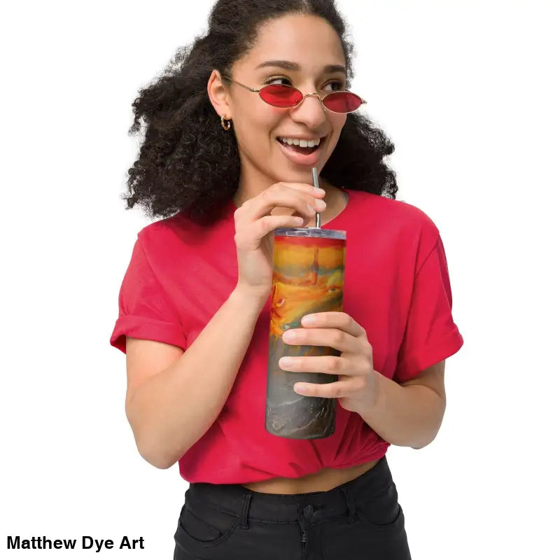 Person in a red t-shirt enjoys a drink from Above the Shadows stainless steel tumbler