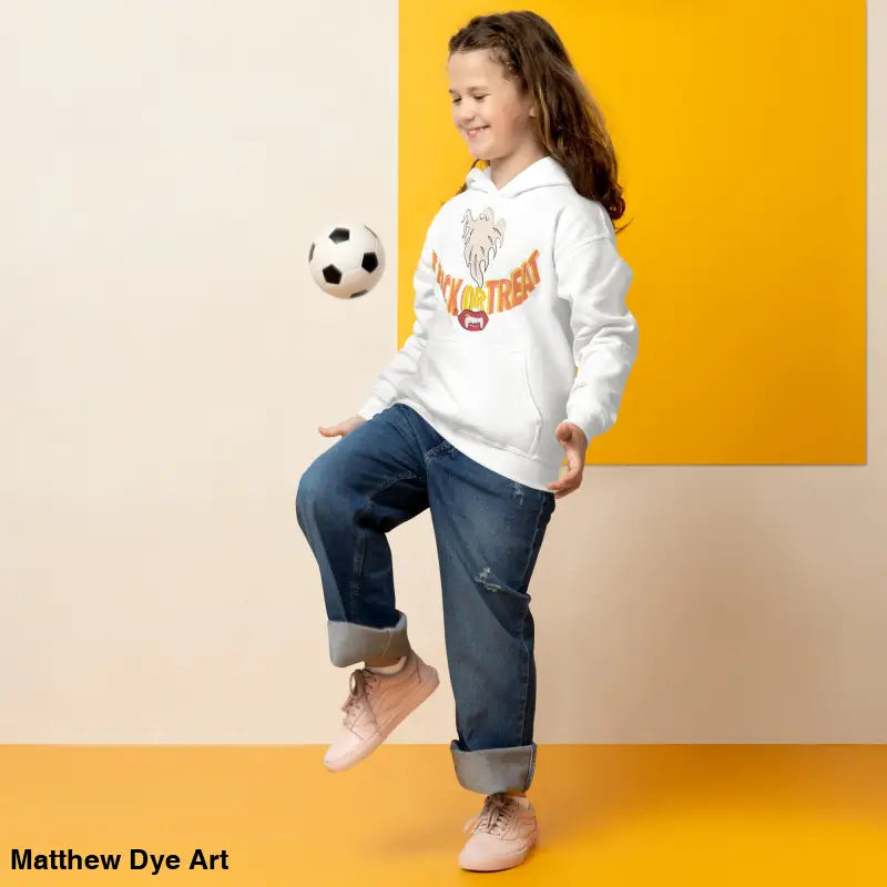 Girl in white hoodie playing with soccer ball, perfect for a child’s Halloween wardrobe