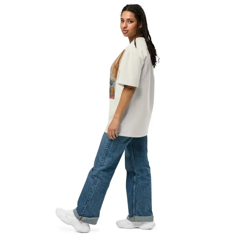 Side view of a model in Phrenology Faded Oversized Tee with blue jeans and sneakers