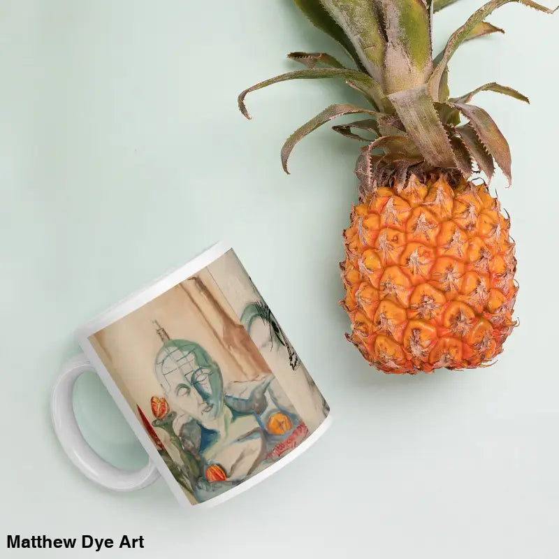 Fresh orange-colored pineapple beside a glossy mug crafted with Matthew Dye art