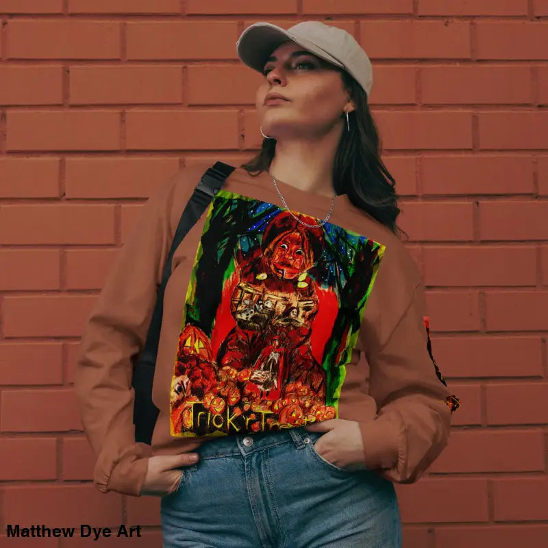 Woman wearing a Trick r Treat unisex long sleeve shirt with colorful Halloween graphic