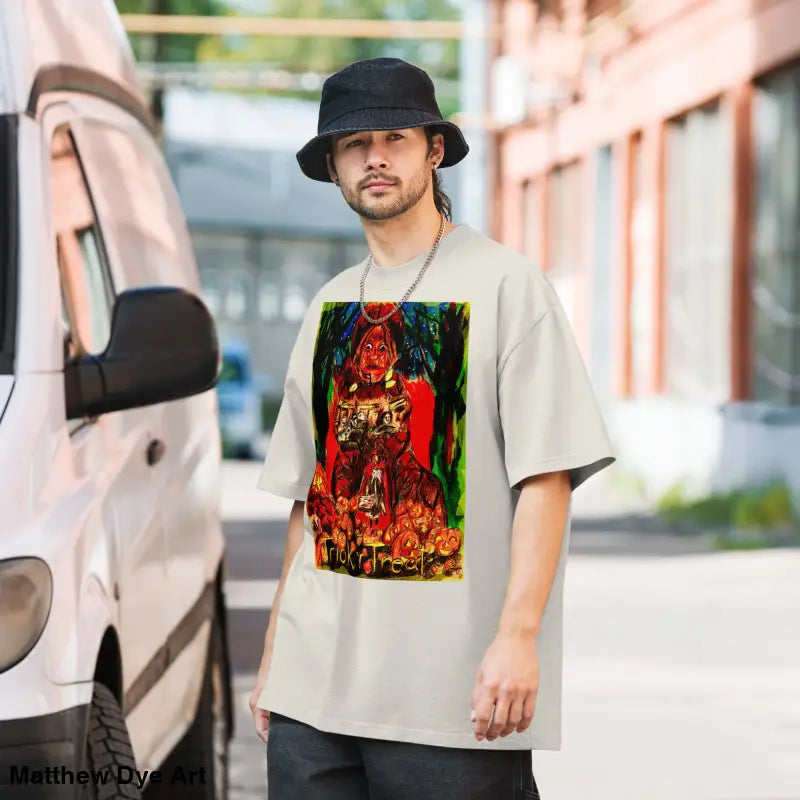 Man wearing oversized faded unisex Halloween tee featuring a haunting jack-o’-lantern design