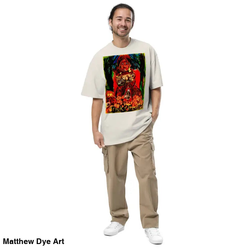 Man in oversized faded unisex Halloween tee featuring a haunting jack-o’-lantern design
