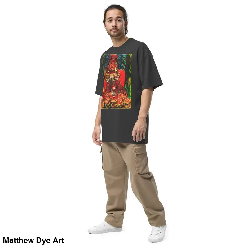 Man in oversized faded unisex Halloween tee featuring haunting jack-o’-lantern art