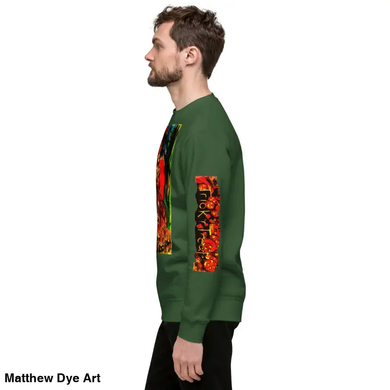 Green unisex premium sweatshirt featuring colorful Trick ’r Treat Halloween design