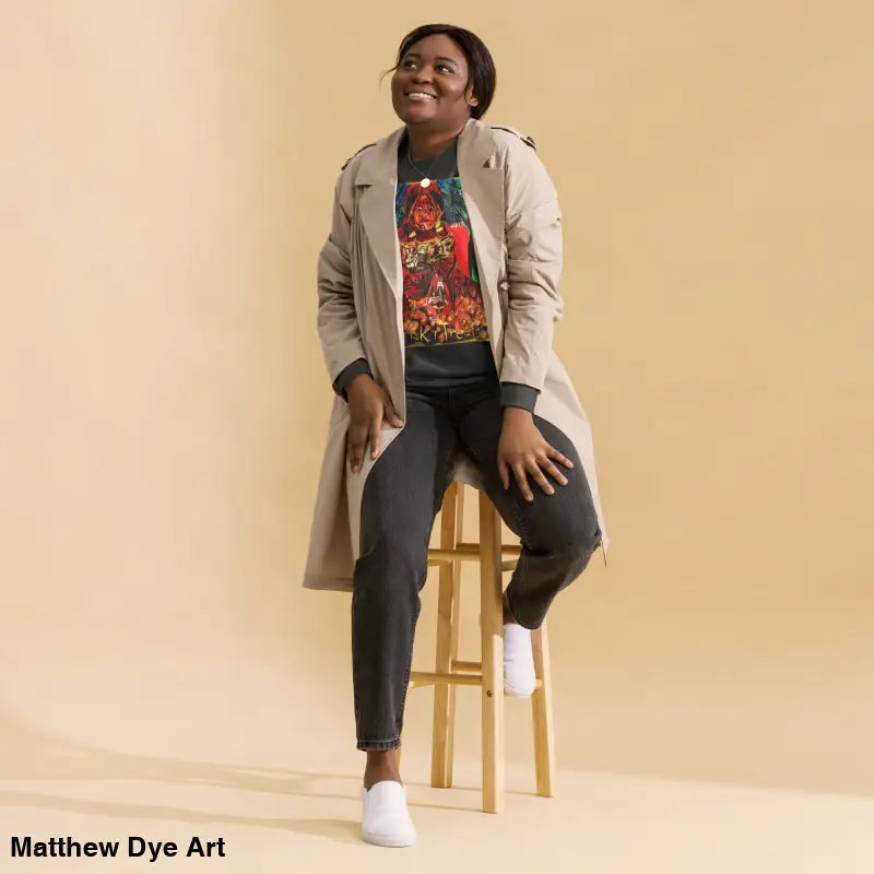 Woman in trench coat sitting on stool, showcasing Trick ’r Treat unisex premium sweatshirt