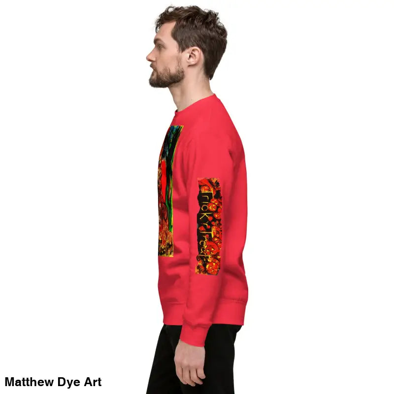 Red unisex premium sweatshirt featuring a colorful Trick ’r Treat Halloween design