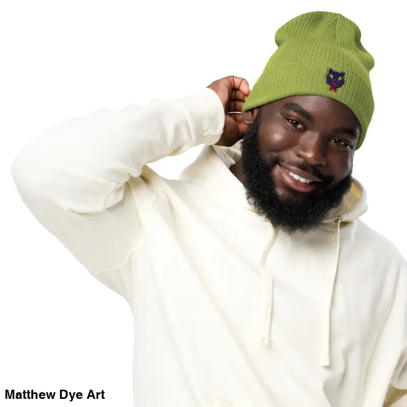 Green knit beanie featuring vintage Halloween cat embroidery, perfect for stylish fall wear