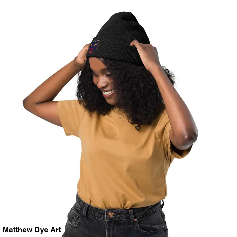 Black knit beanie featuring a colorful vintage Halloween cat design for unisex wear