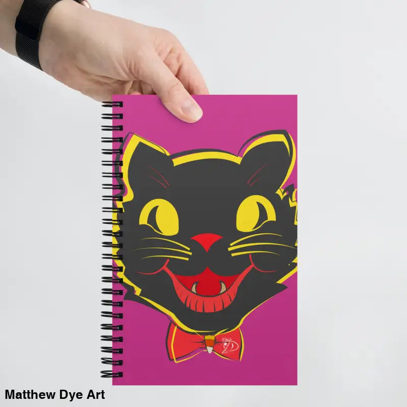 Spiral-bound notebook with black cat graphic on delightful flamingo background design