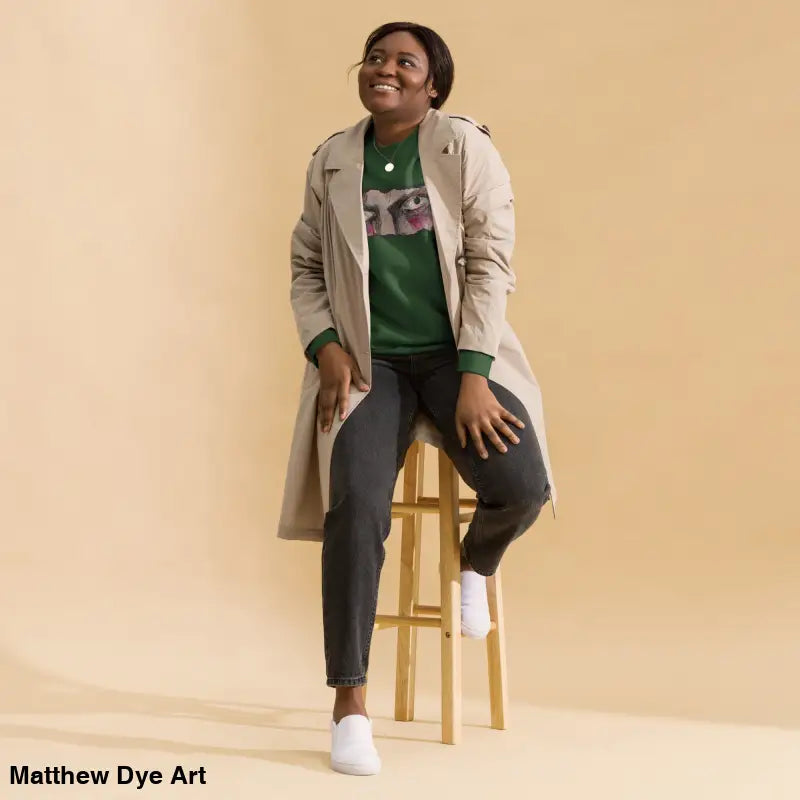 Woman in green sweatshirt and trench coat showcasing urban elegance in classic sweatshirt silhouette