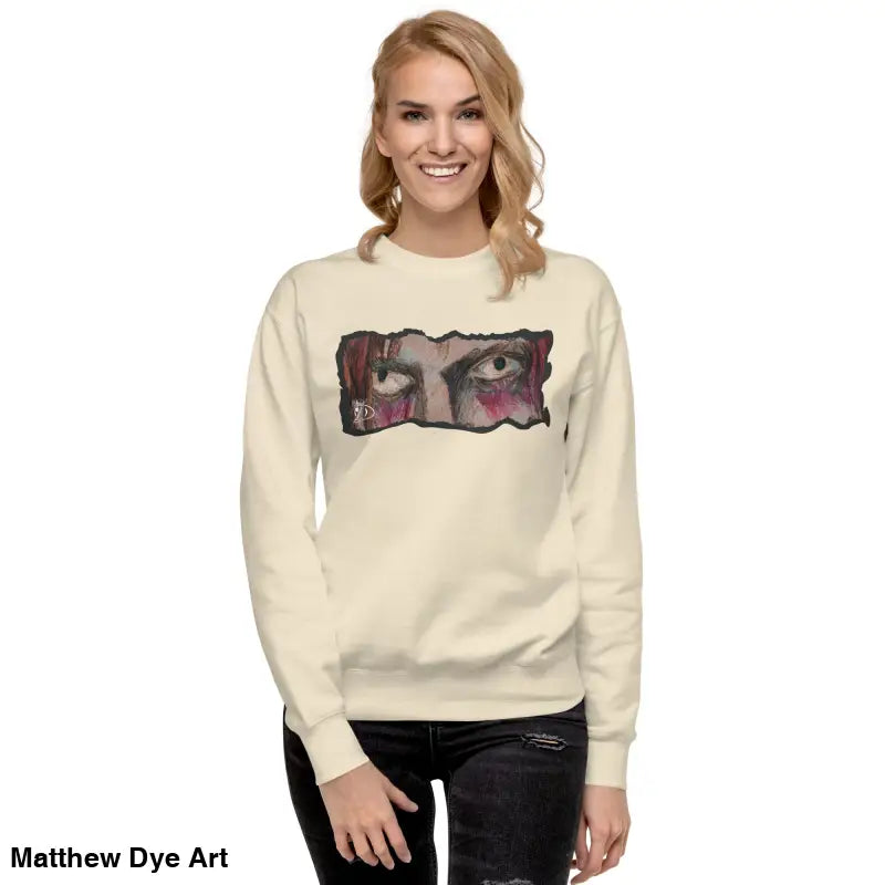 Woman in a cream sweatshirt with graphic print, showcasing urban elegance and classic silhouette