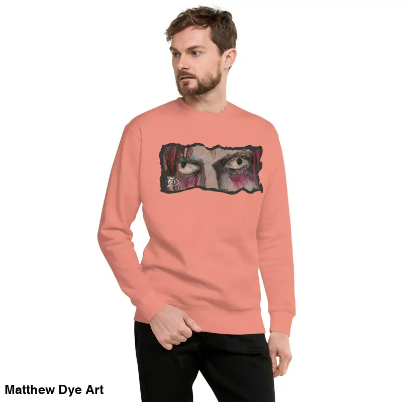 Salmon-colored Watcher’s Gaze Unisex Sweatshirt with eye graphic in classic sweatshirt silhouette