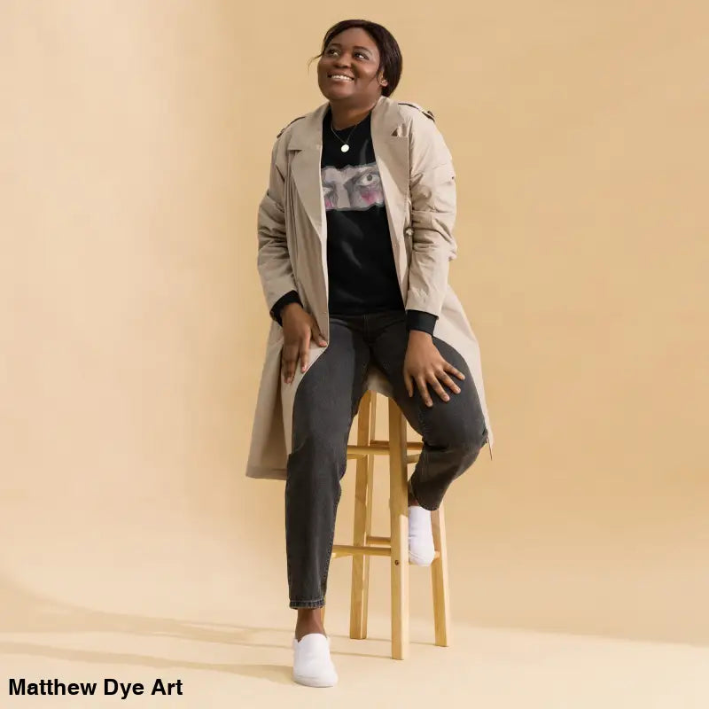 Woman in trench coat showcasing the Watcher’s Gaze Unisex Sweatshirt, a timeless piece enriched in urban elegance