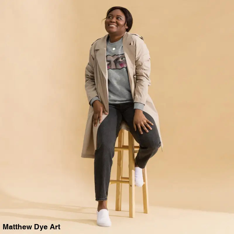 Woman in gray sweatshirt and trench coat showcasing urban elegance in a timeless piece