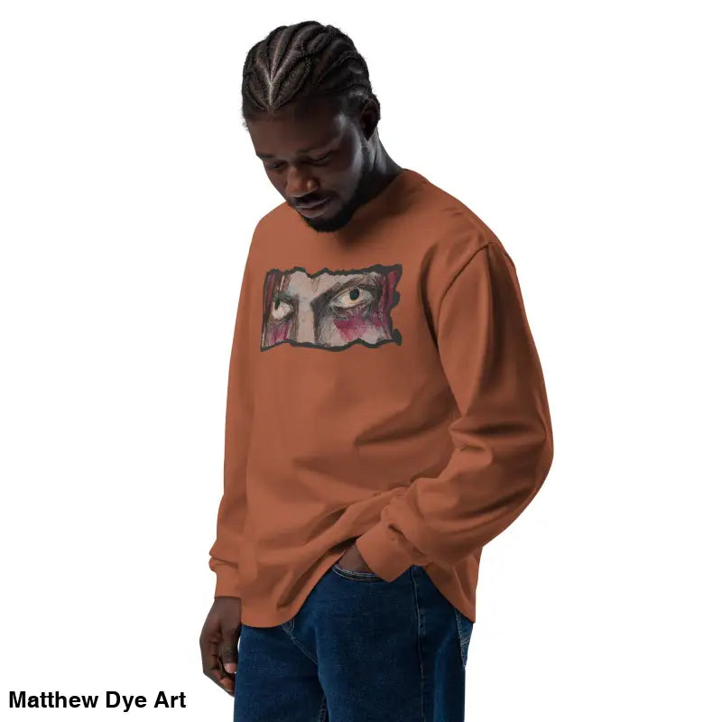 Man wearing a brown sweatshirt with eye graphic from Watcher’s Veil elegant premium long sleeve
