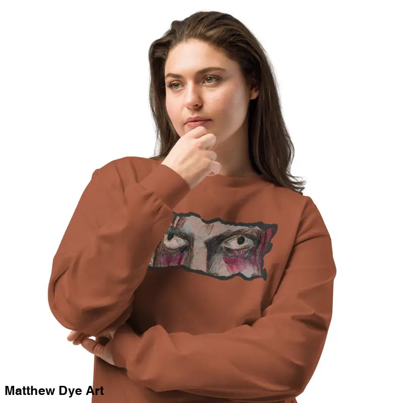 Woman in brown sweatshirt with eye graphic showcasing elegant premium long sleeve style
