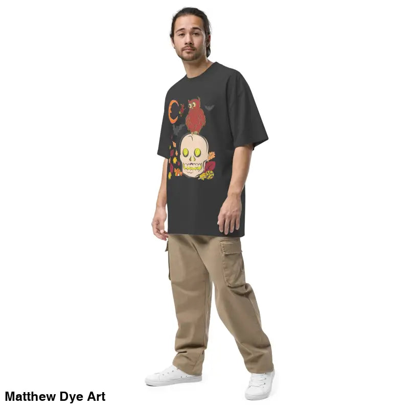 Man showcasing an oversized faded t-shirt in a Halloween theme, perfect for Haunted Harvest